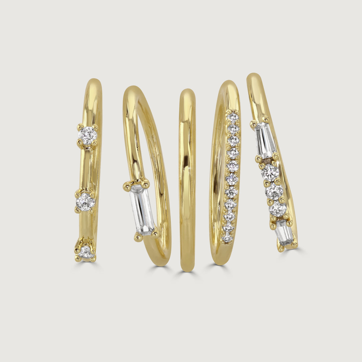 Five piece stacking rings in gold tone and crystal by Buckley London