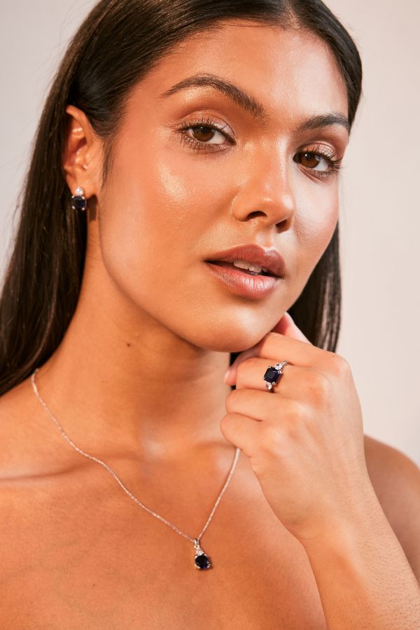 Model wears part of the sapphire carat collection range. Earrings, pendant and ring